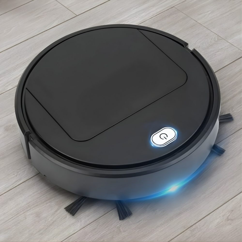 Fekete robotporszívó világos fa hatású padlón, világító bekapcsológombbal és kék fényperemmel, oldalkefékkel. 2