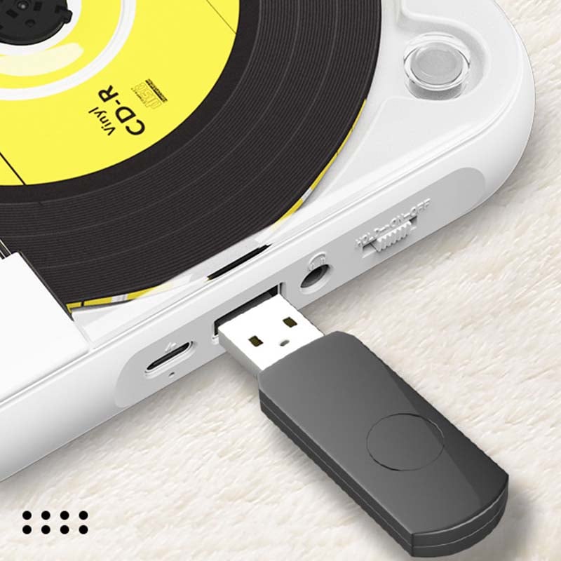 Közeli kép a lejátszó oldaláról: a töltőport, az USB-nyílba dugott fekete pendrive, a fejhallgató-csatlakozó és a kapcsoló. 9