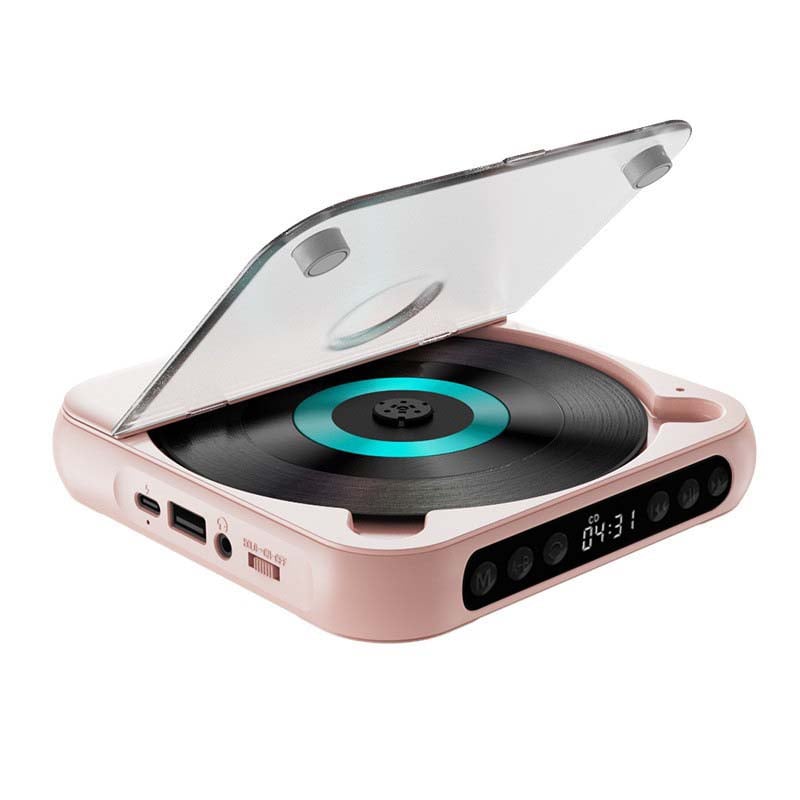 Rózsaszín CD-lejátszó nyitott fedéllel fehér háttéren, türkiz gyűrűs lemezzel, töltőporttal, USB-vel és fejhallgató-csatlakozóval. 14