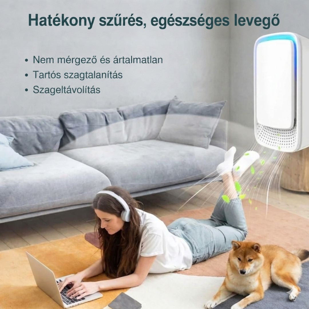 Nappaliban a földön hason fekvő, fejhallgatós nő laptopozik, mellette kutya, a falon a készülék friss levegőt áraszt 7