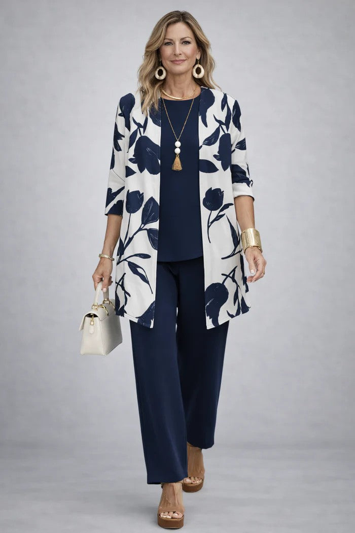 Modell sötétkék felsőben és nadrágban, fehér alapon sötétkék virágmintás nyitott kardigánnal. 15