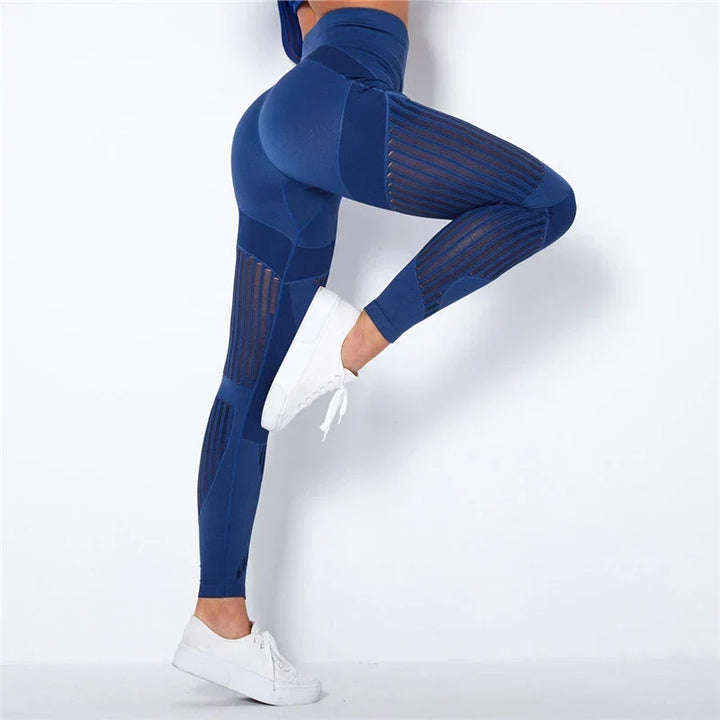 Kék leggings oldalról, felemelt lábú modellen, jól látszanak az áttört csíkos betétek 3